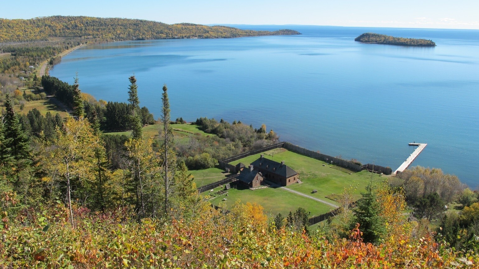 Photograph of the historic depot and dock on Grand Portage Bay at Lake Superior. Hat Point and Pete's Island are in the distance (50364188-17a1-43f4-9ca0-d6ab3315f72c).jpg